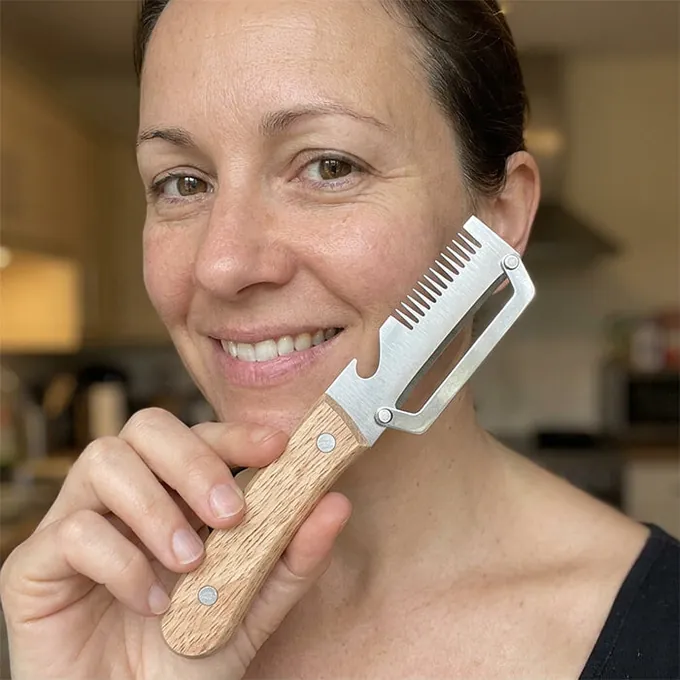 A smiling woman holds PeelPro up near her face